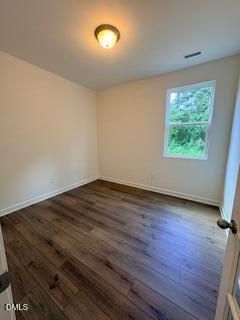 Bright bedroom with wood-look flooring in The Willow B floor plan at Woodland Crossing in Zebulon, North Carolina.