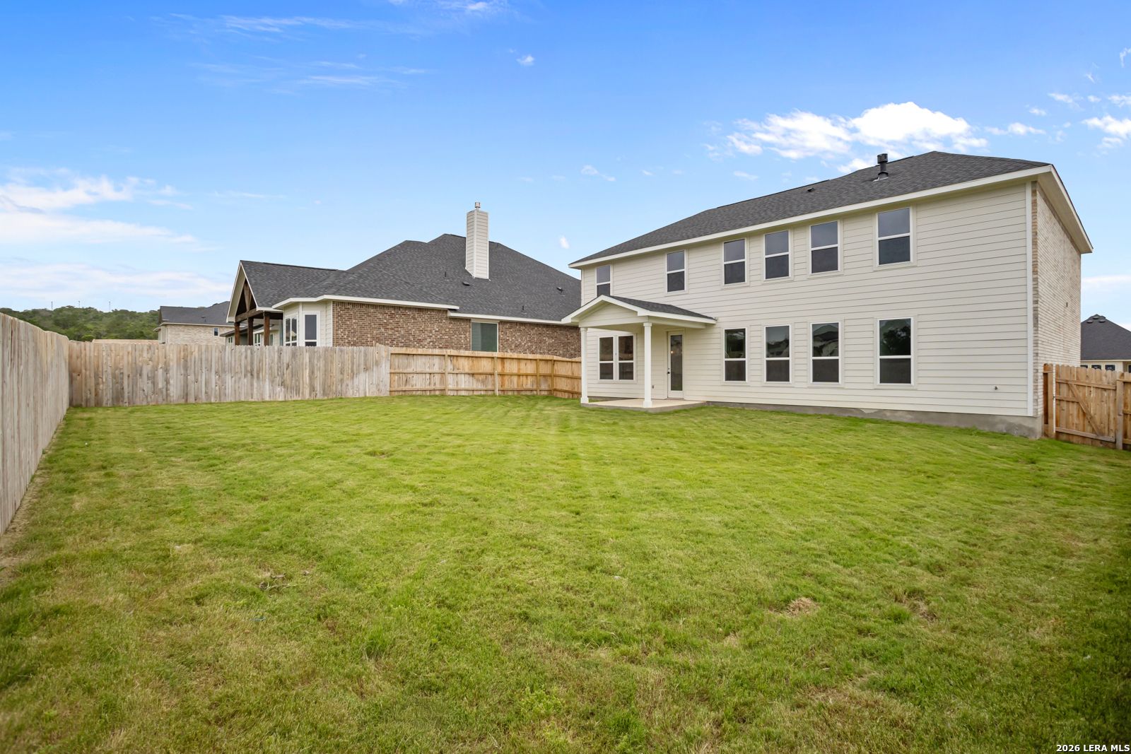 Large, fenced backyard of a 2-story Danbury H floor plan home by Davidson Homes in The Reserve at Potranco Oaks, TX.