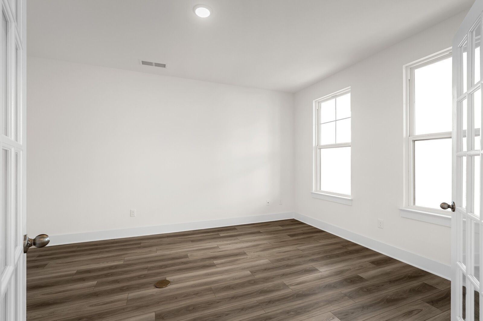 Bright home office or bonus room with French doors and wood-look flooring in The Henry C floor plan, Mt. Juliet, Tennessee.