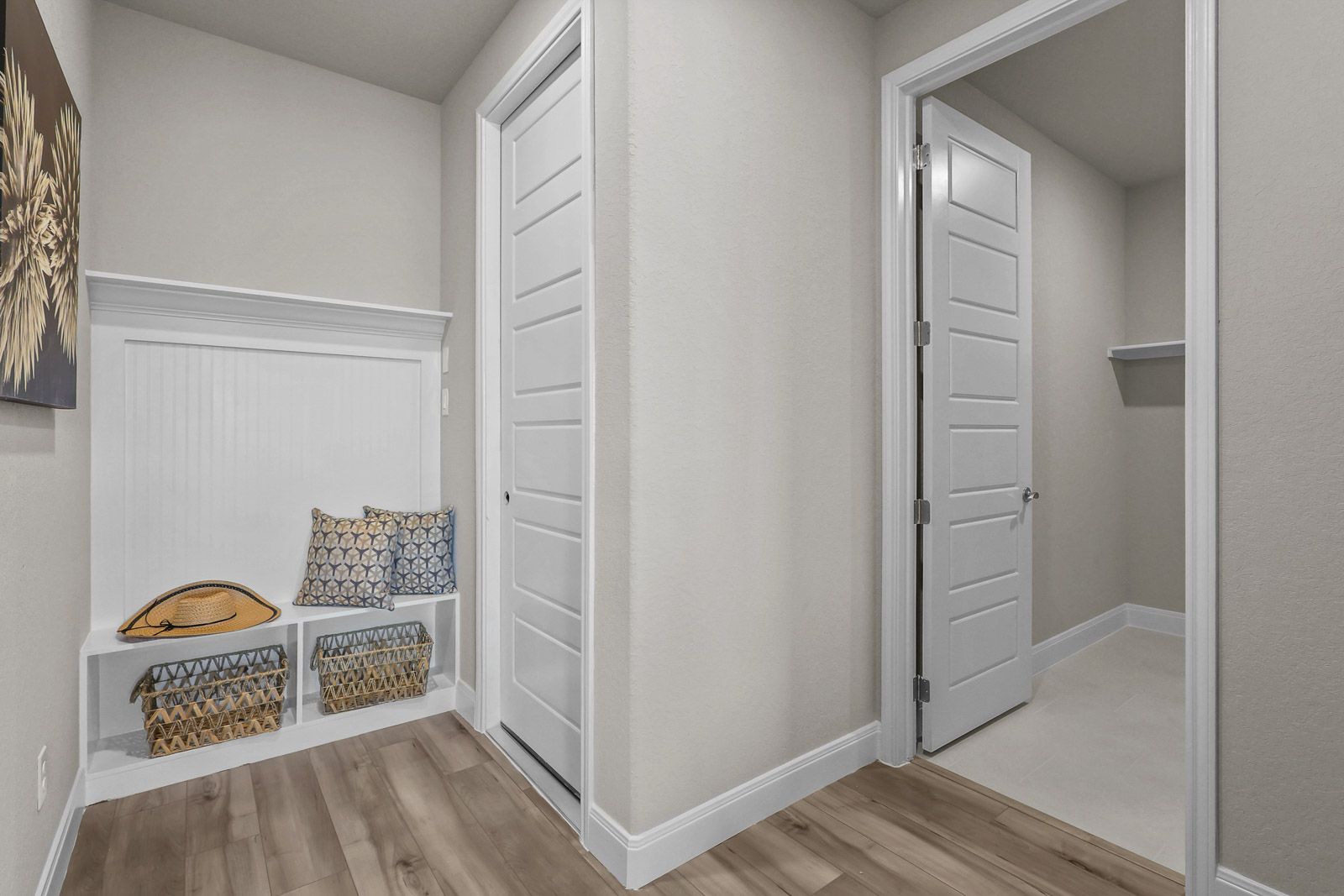 Mudroom entry with built-in storage bench and walk-in closet in The Jennings G home design by Davidson Homes.
