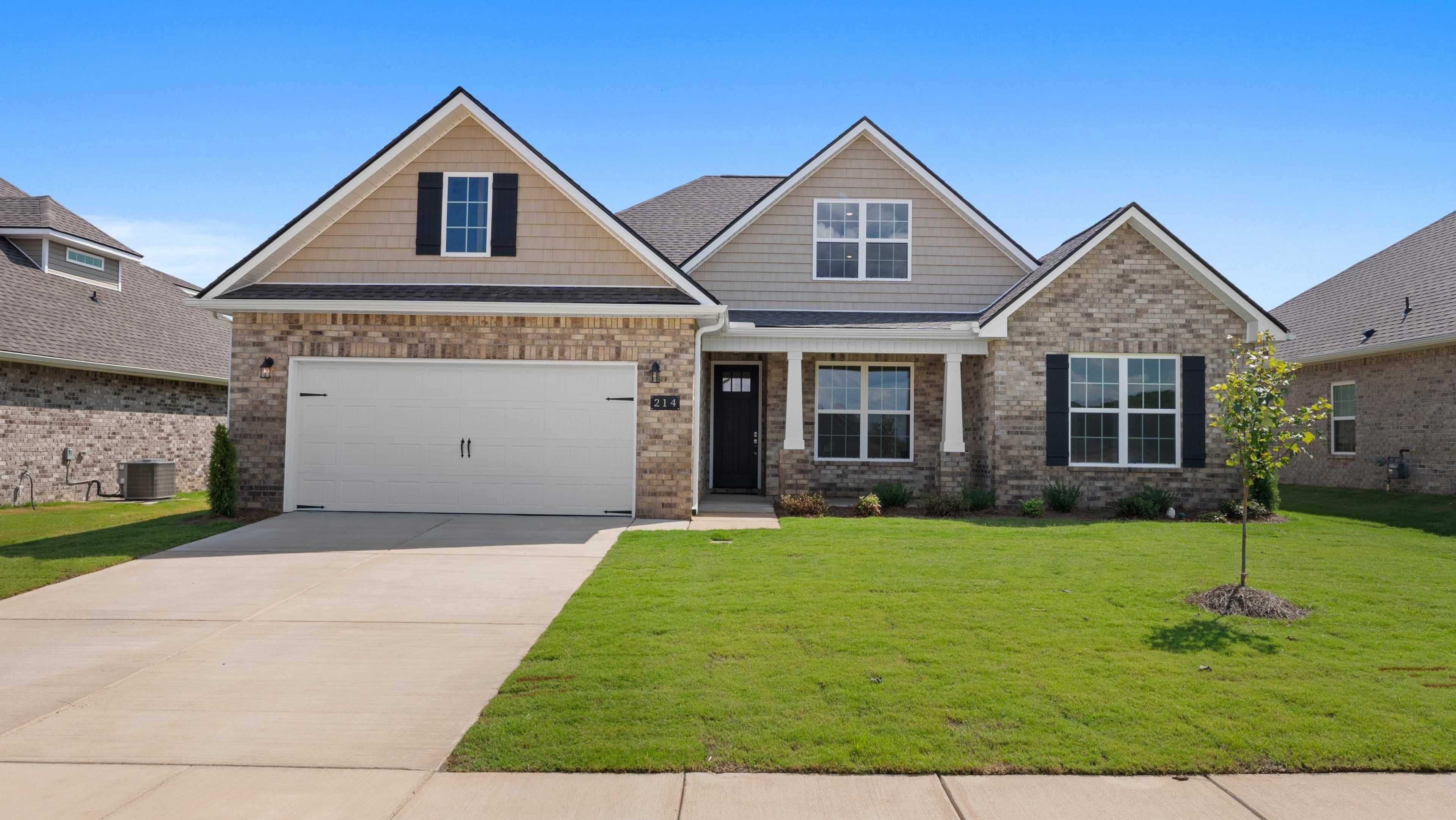Modern Davidson Homes open house at 214 White Horse Way: beige stone-accented single-story home with gabled roof, garage, porch, and manicured lawn