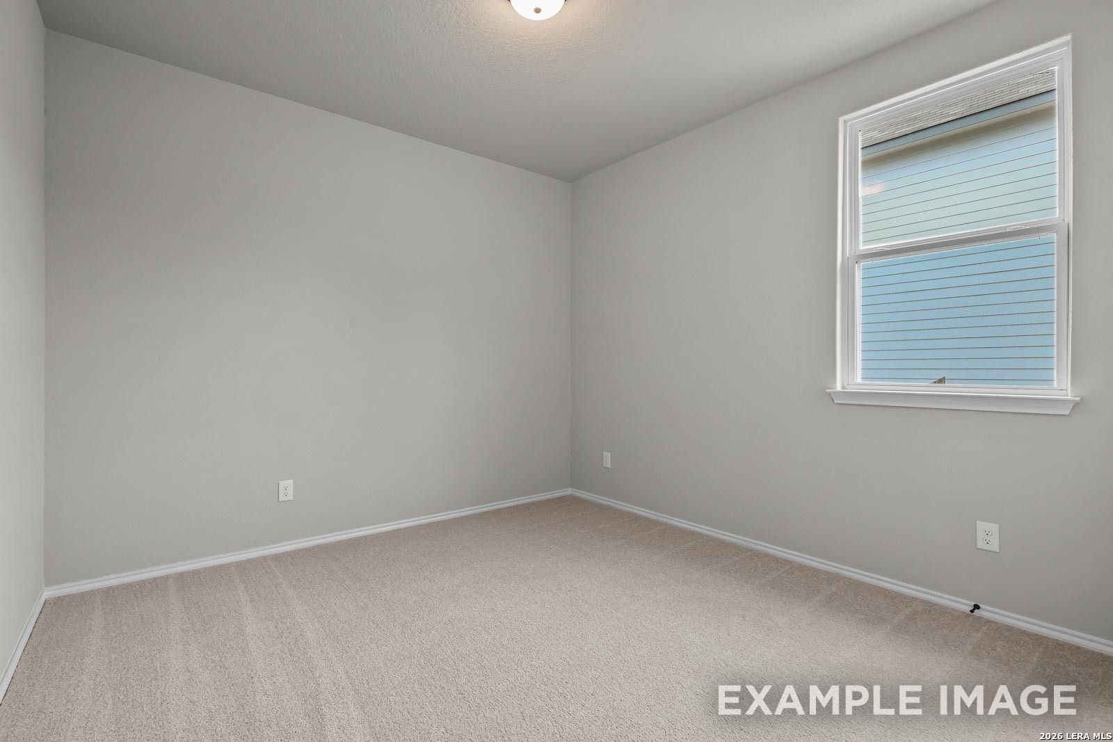 Bright, spacious secondary bedroom with neutral carpet in The Glenwood E floor plan at Royal Crest, San Antonio, Texas.