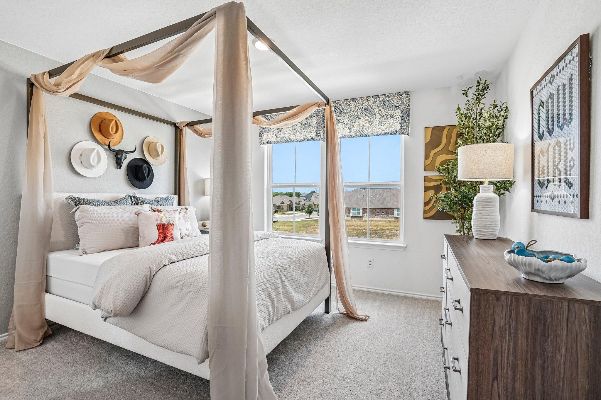 Western-themed bedroom with canopy bed at Morgan Meadows in San Antonio, TX, featuring stylish decor and neutral tones.