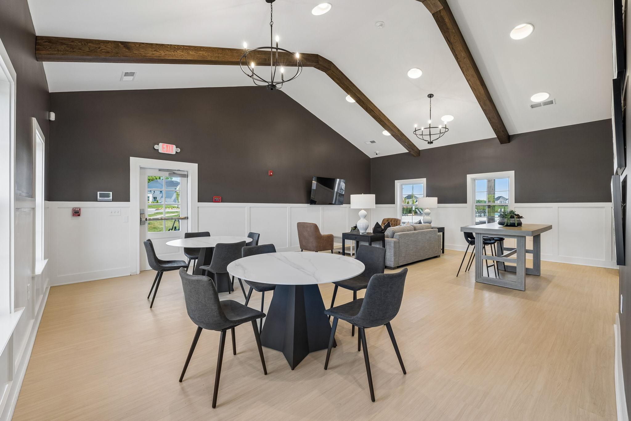 Spacious community clubhouse at Bradshaw Farms in Mt. Juliet, TN featuring modern seating areas and vaulted wood-beam ceilings.