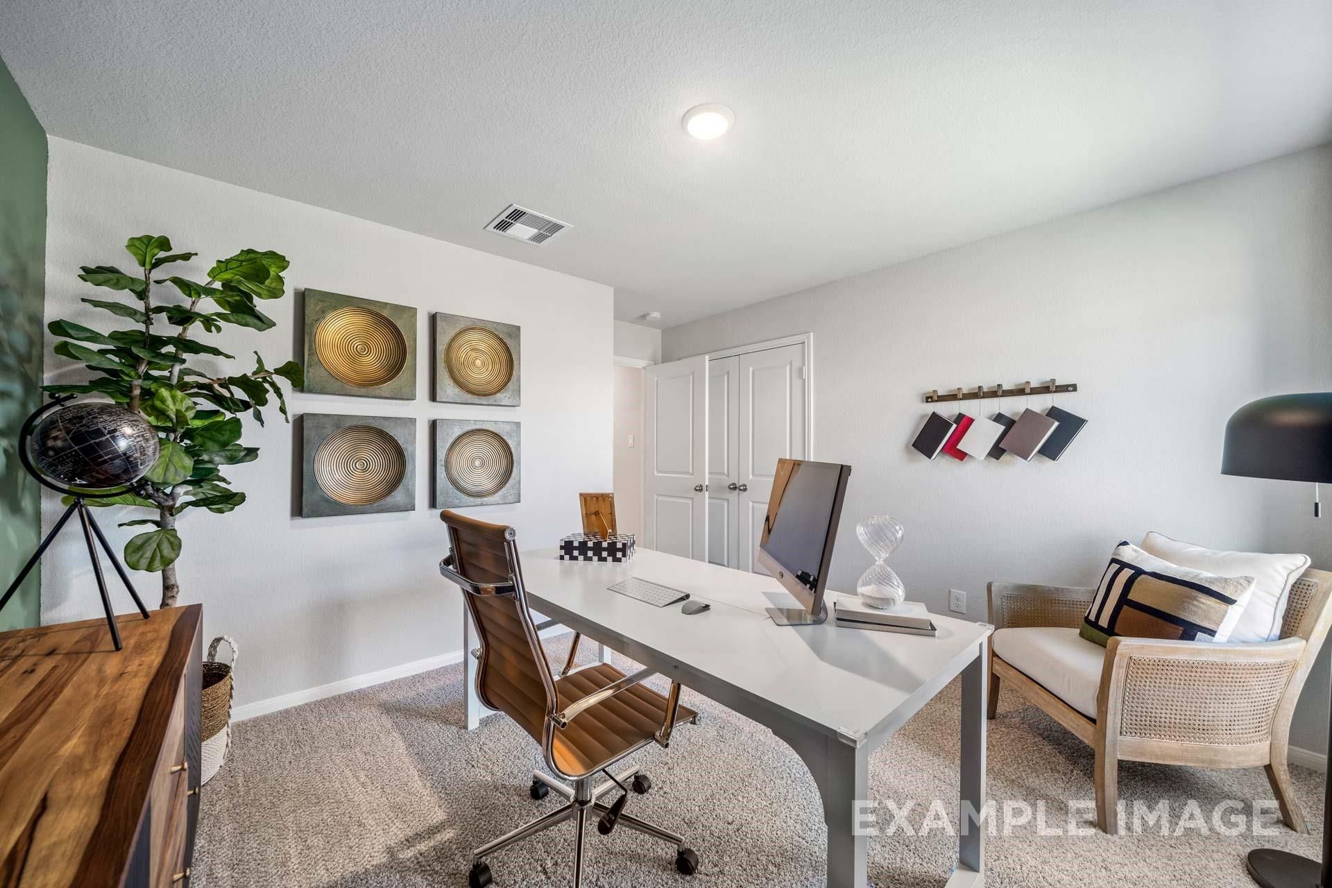 Modern home office with wooden desk, ergonomic chair, plants, and wall art in Davidson Homes The Acadia A, Lago Mar, Texas