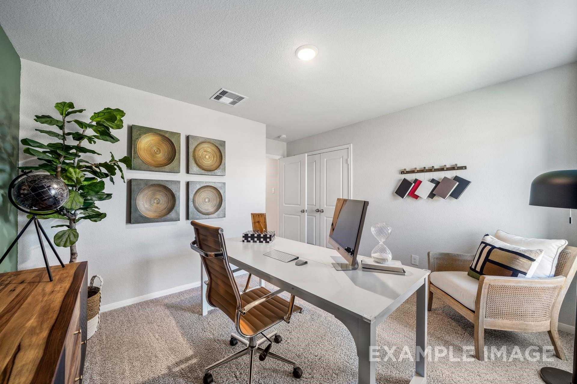 Modern home office with wooden desk, ergonomic chair, plants, and wall art in Davidson Homes The Acadia A, Lago Mar, Texas