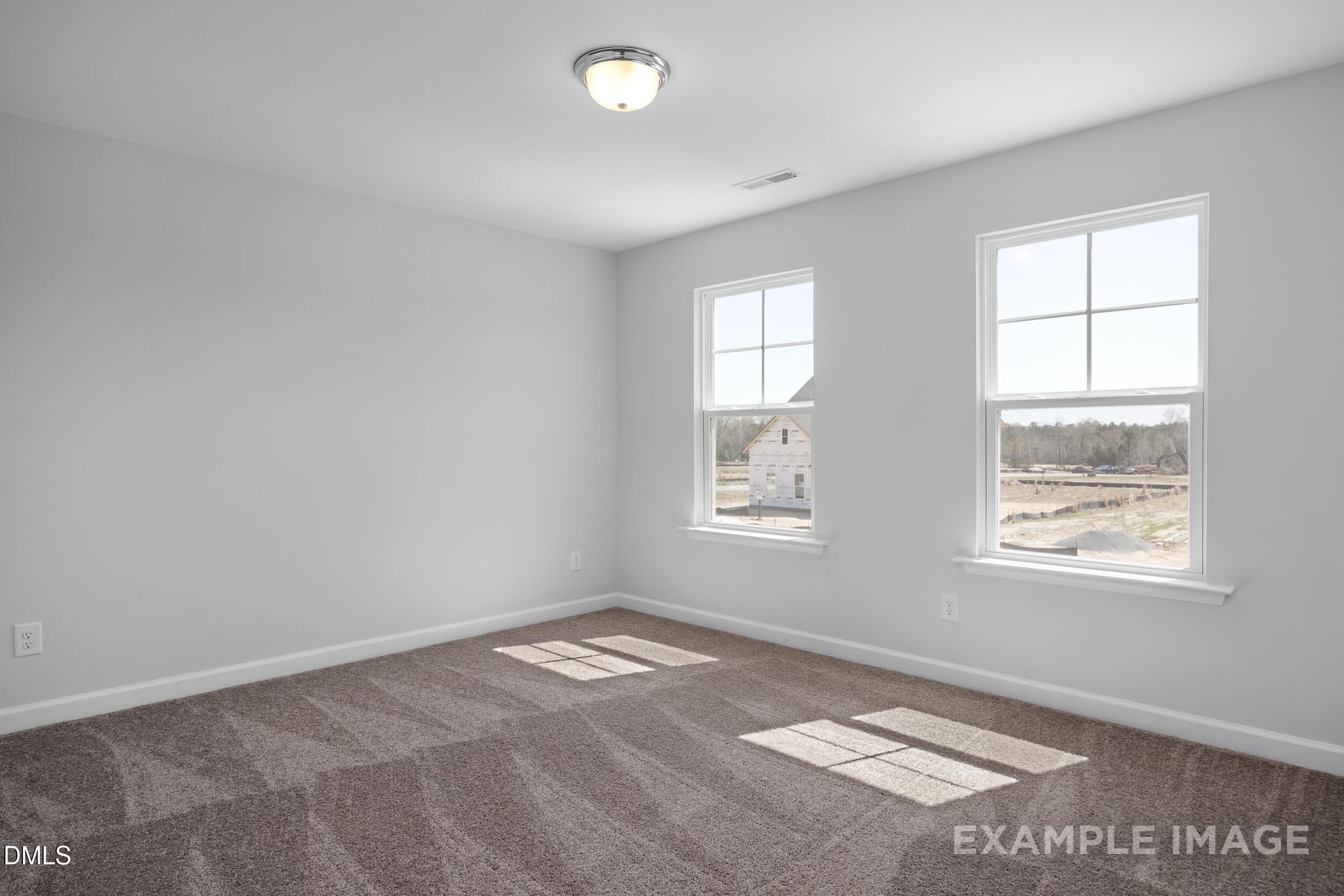 Bright, carpeted bedroom with natural light in The Gavin A floor plan at Gregory Village, Lillington, North Carolina.
