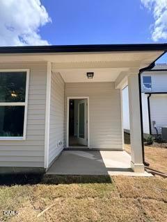 Covered concrete patio entrance of The Daphne D floor plan by Davidson Homes in Woodland Crossing, Zebulon, North Carolina.