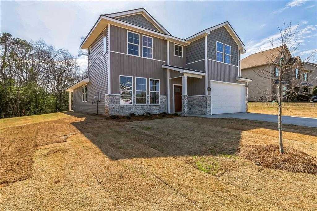 Modern two-story gray home with 2-car garage, front porch, and landscaped yard in Ivy Glen, Perry, Georgia - Evermore Homes The Stella