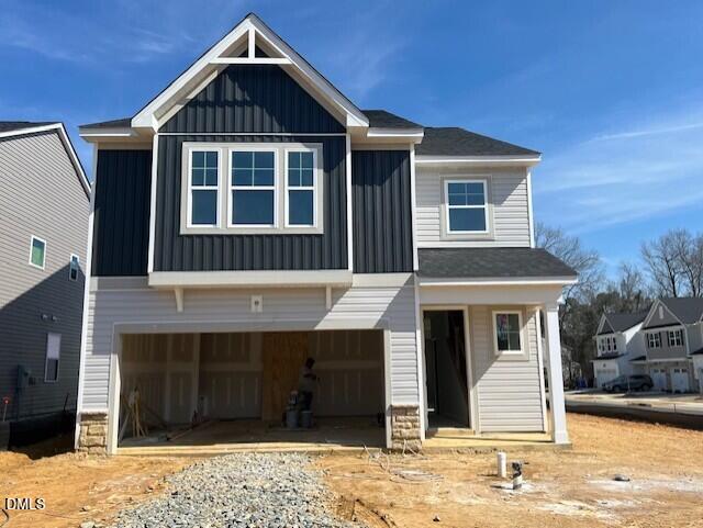 Front view of two-story Adalynn A home under construction by Davidson Homes in Gregory Village, Lillington, NC, with open 2-car garage