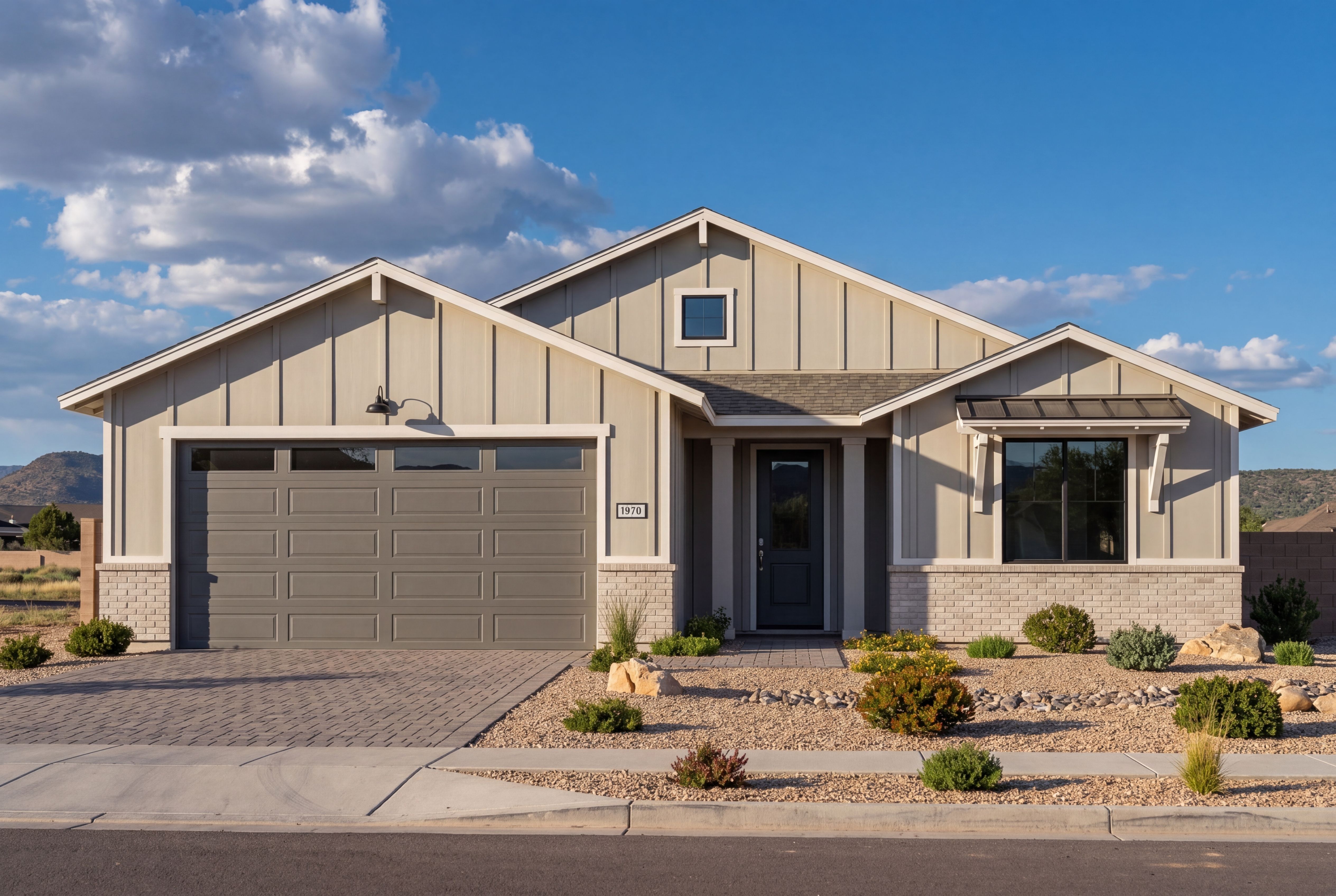 Modern farmhouse exterior of The Sheridan II G in Prescott with 3-car garage, board-and-batten siding, and stone accents.
