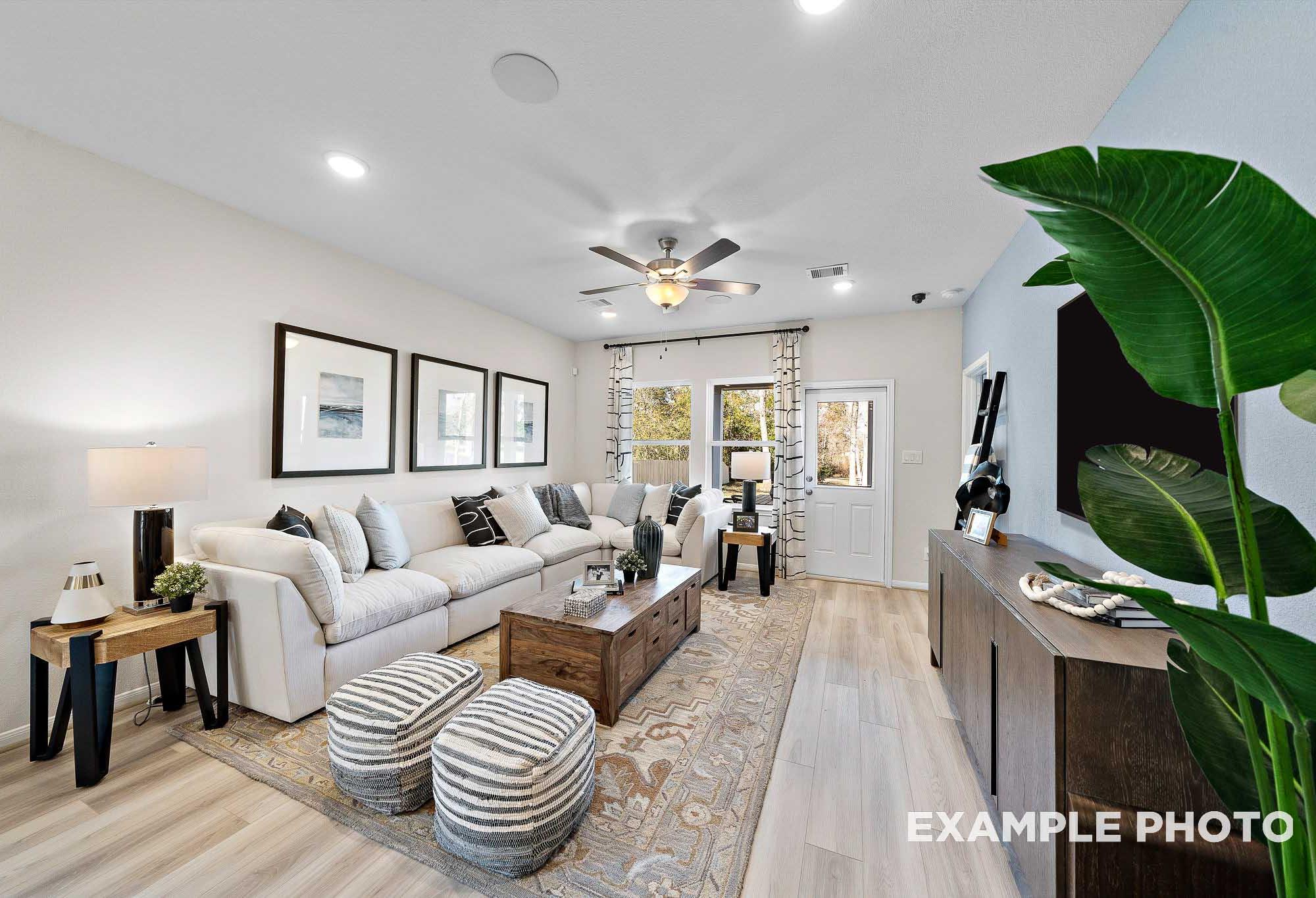 Bright and airy open-concept living room in The San Marcos featuring cozy sectional seating and modern home decor.