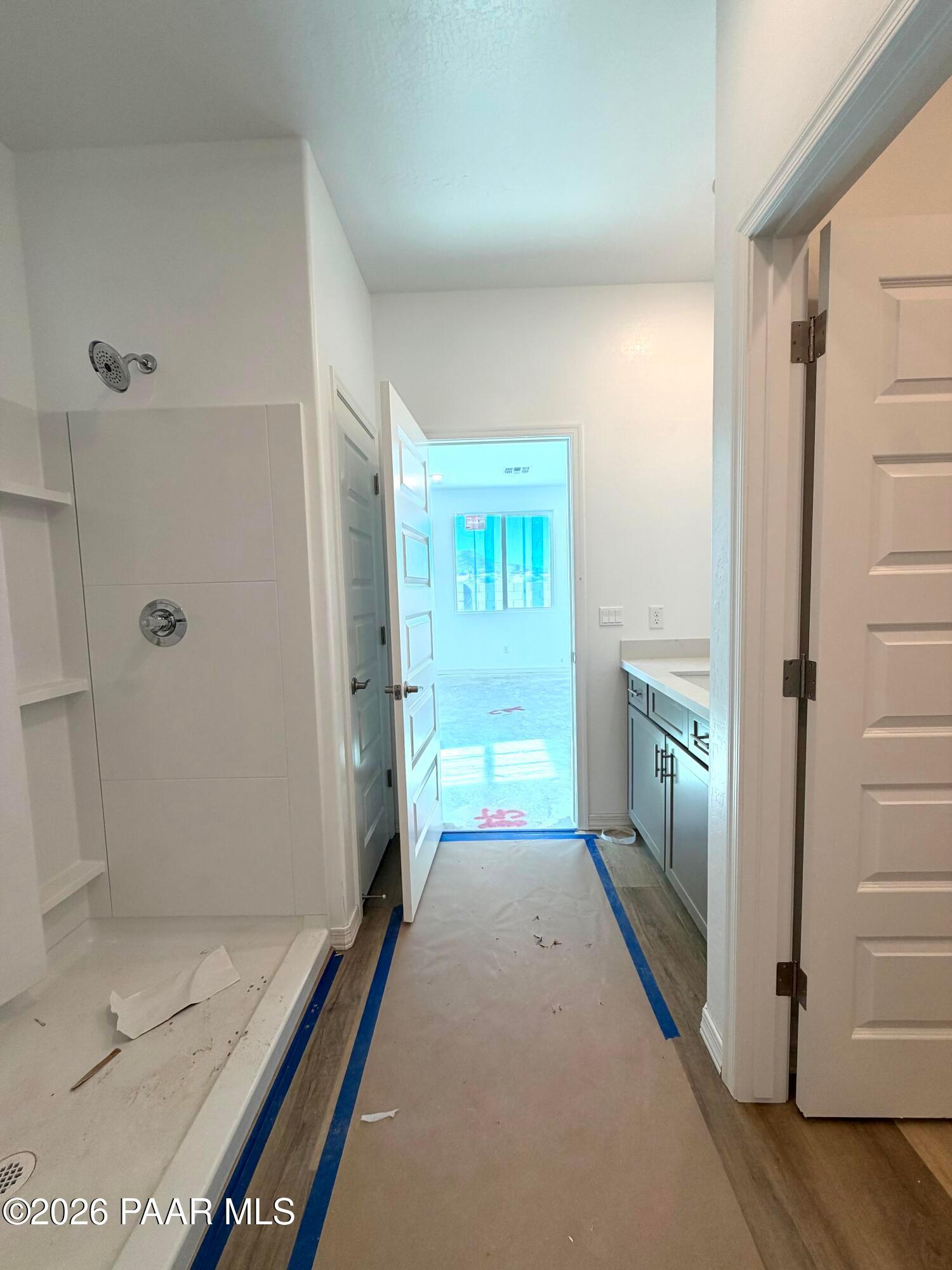 Walk-in tile shower and gray vanity cabinets in master bathroom of Davidson Homes Marietta C plan in Prescott, Arizona