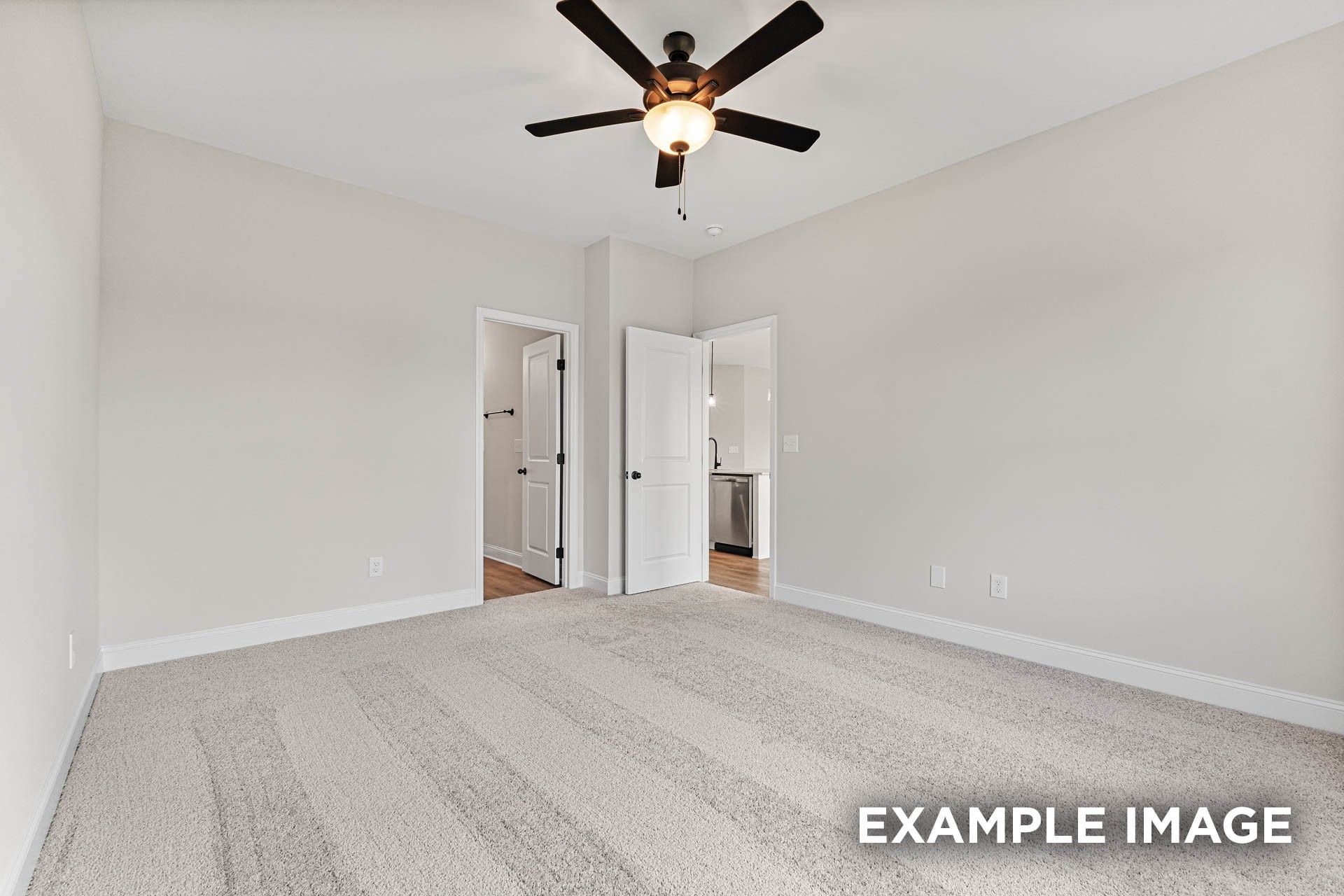 Spacious bedroom with plush carpet and ceiling fan in The Franklin E floor plan at Bailey Park, Fayetteville, Tennessee.
