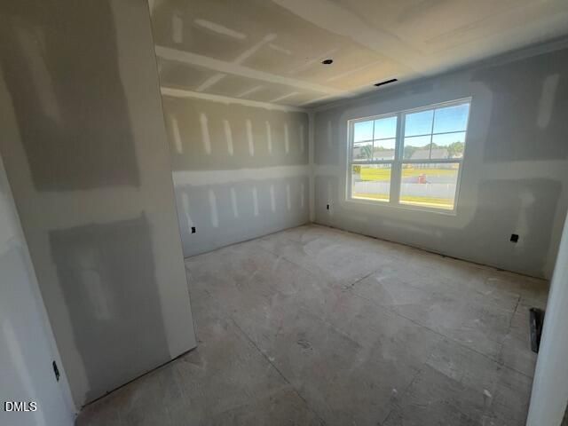 Unfinished bedroom with drywall and large window in Davidson Homes The Ash C new construction home, Lillington, North Carolina