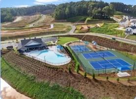 Clubhouse with swimming pool and tennis courts in green community setting, Hemingway by Davidson Homes, Cumming, Georgia
