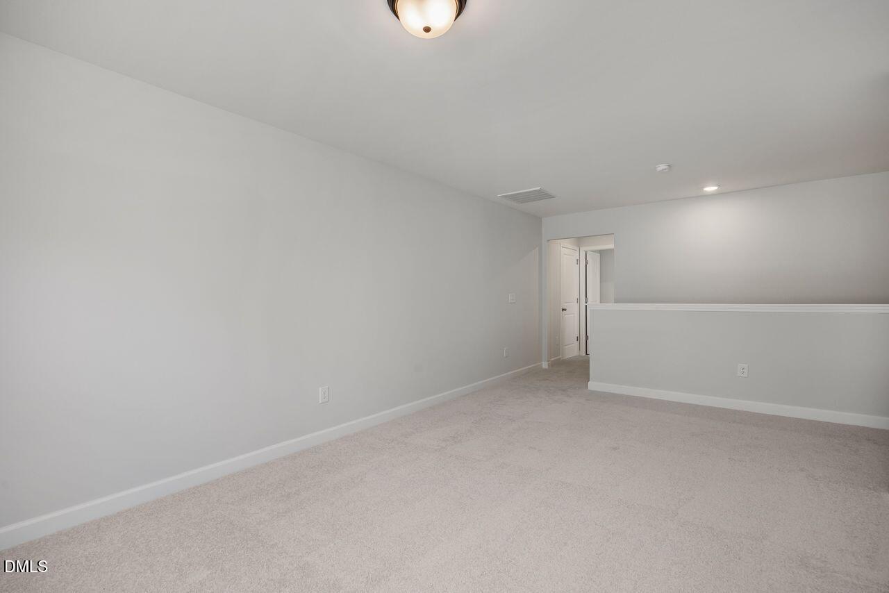Spacious carpeted loft area in The Birch II A floor plan by Davidson Homes in Montrose, Aberdeen, North Carolina.