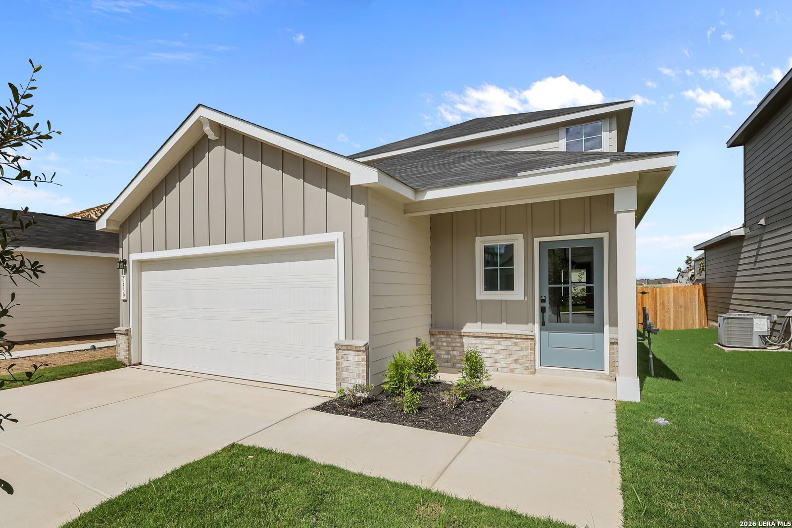 Front exterior of Davidson Homes The Summit B with 2-car garage and covered porch in Morgan Meadows, San Antonio, Texas