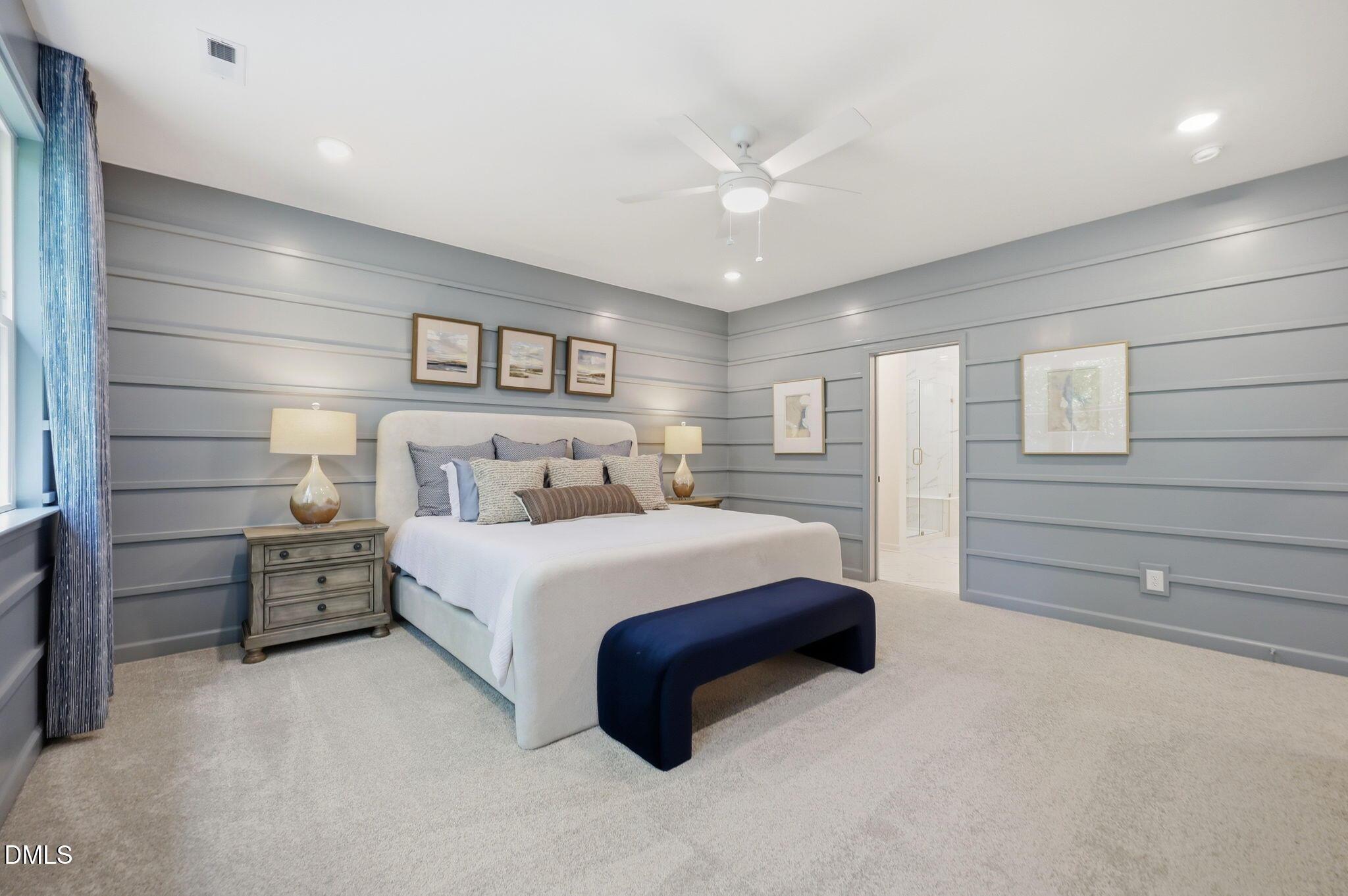 Spacious primary bedroom with blue shiplap walls in The Aspen B floor plan at Wendell Ridge, Wendell, North Carolina.