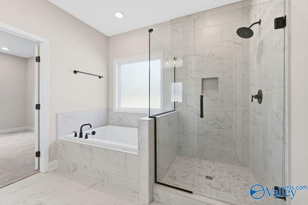 Modern master bathroom with frameless glass shower, soaking tub, and subway tile in Davidson Homes The Montgomery B, Hartselle, AL