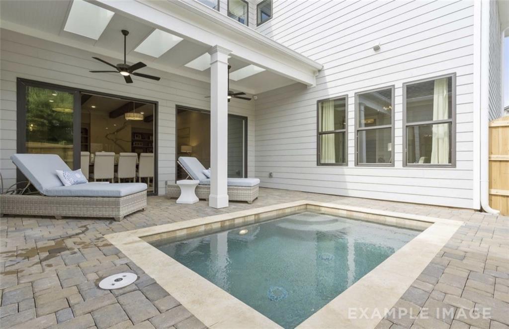 Covered patio with lounge chairs and private plunge pool in Davidson Homes Seaside A backyard, Woodstock, Georgia