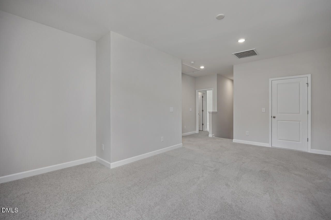 Spacious carpeted loft area in The Ashport L floor plan by Davidson Homes at Sage on North Main, Wake Forest, NC.
