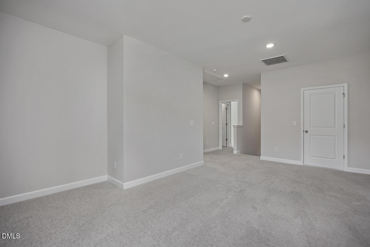 Spacious carpeted loft area in The Ashport L floor plan by Davidson Homes at Sage on North Main, Wake Forest, NC.