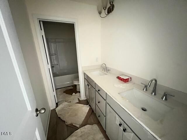 Double vanity bathroom with tub-shower combo in The Hickory II B floor plan at Retreat at North Main, Lillington, NC.