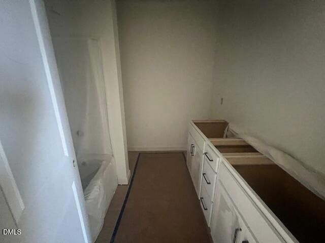 Bathroom under construction with white vanity cabinets, tub, and shower in Davidson Homes' The Magnolia II B, Lillington, North Carolina