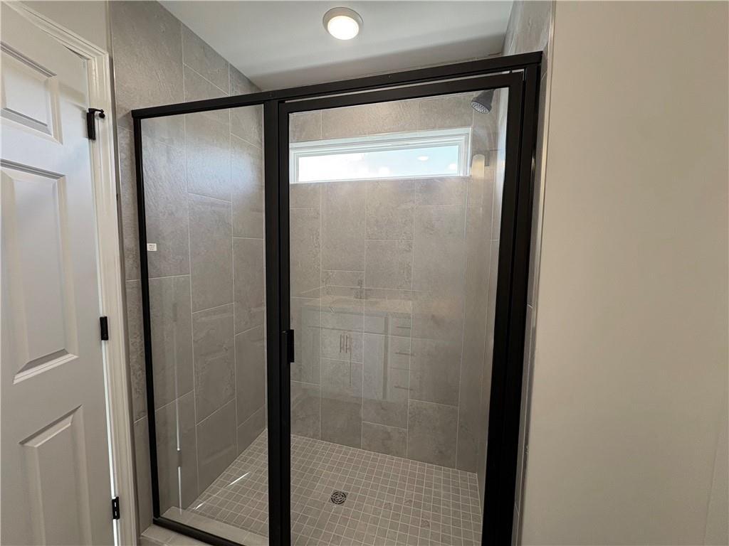 Modern frameless glass shower with subway tile walls and transom window in master bath, Davidson Homes The Wake E, Cumming GA