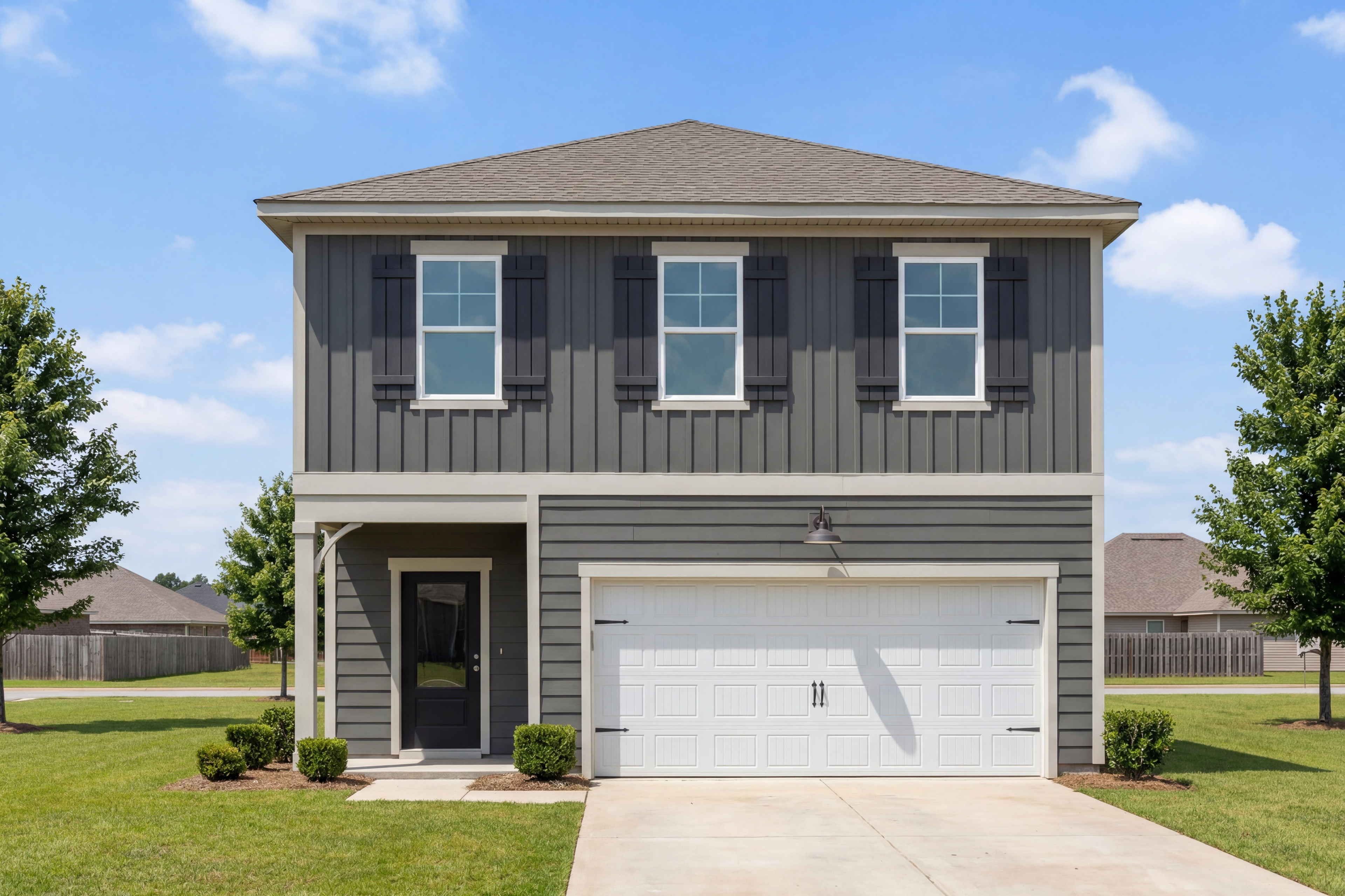 Two-story exterior of The Burton B home design in Cullman, Alabama featuring dark gray siding and a two-car garage.