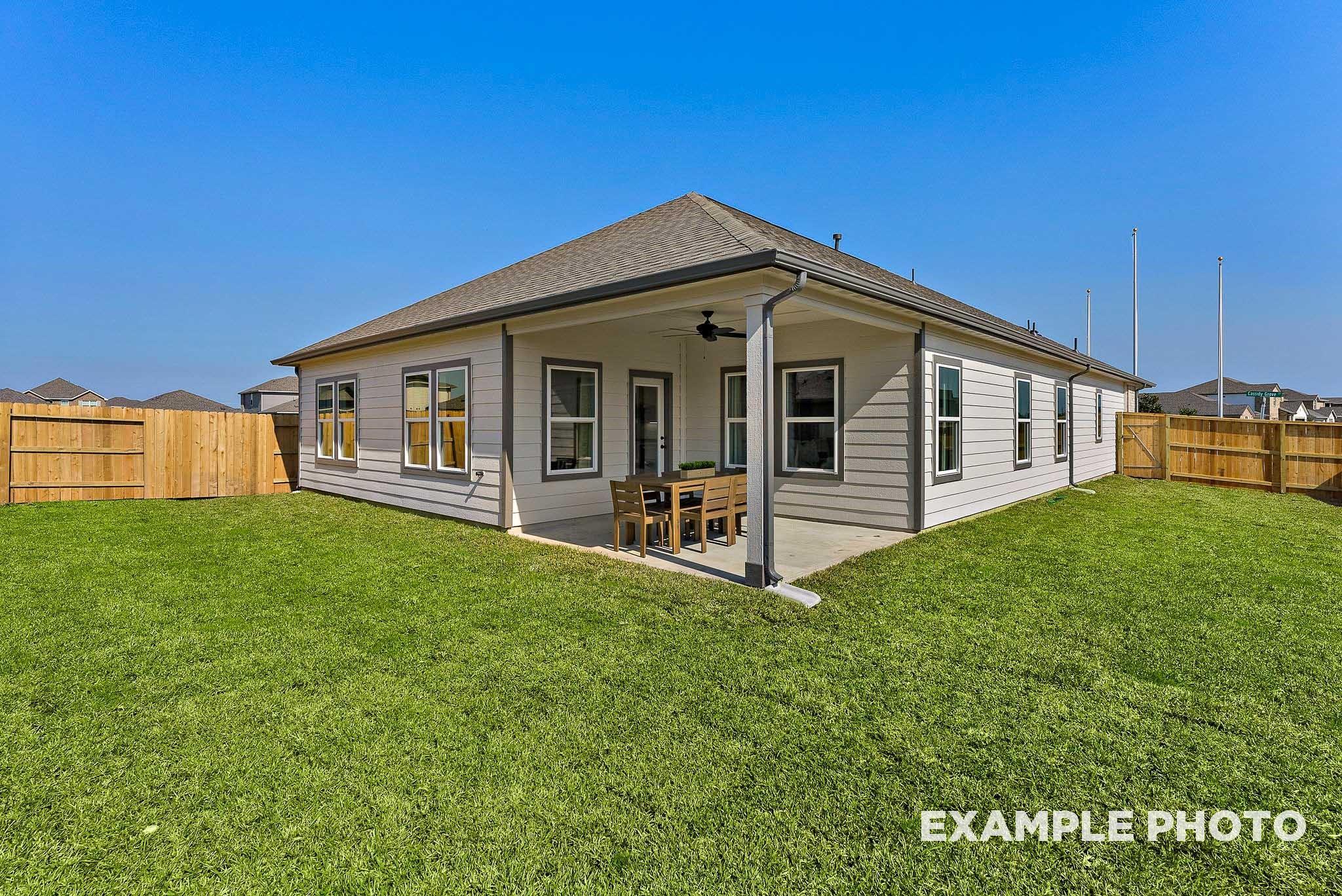 Covered patio and spacious backyard of The Everett E floor plan by Davidson Homes in Sundance Cove, Crosby, Texas.