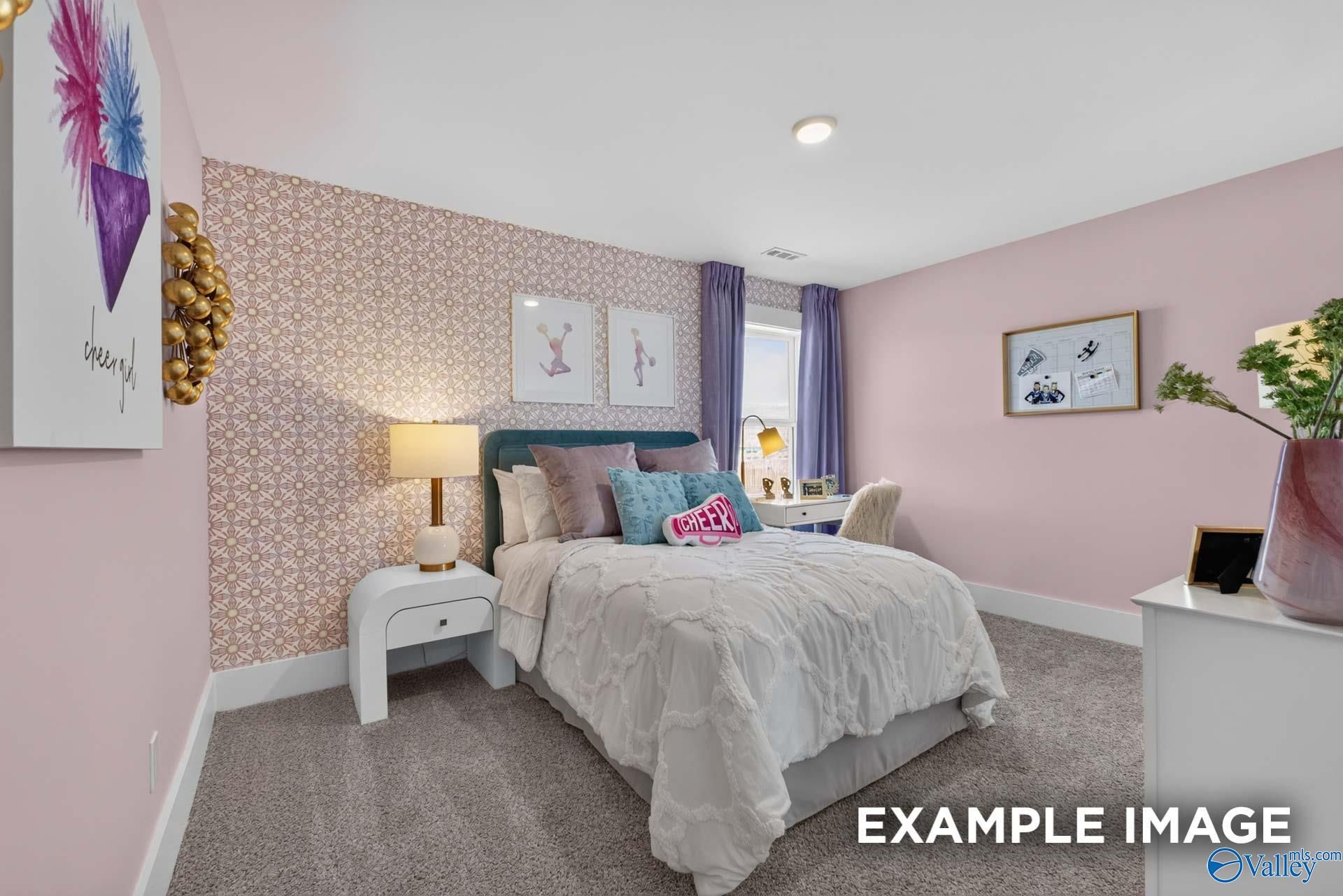 Charming pink bedroom with patterned accent wall and cozy bed in Davidson Homes Ashport K plan, Forest Glen, Hazel Green, Alabama