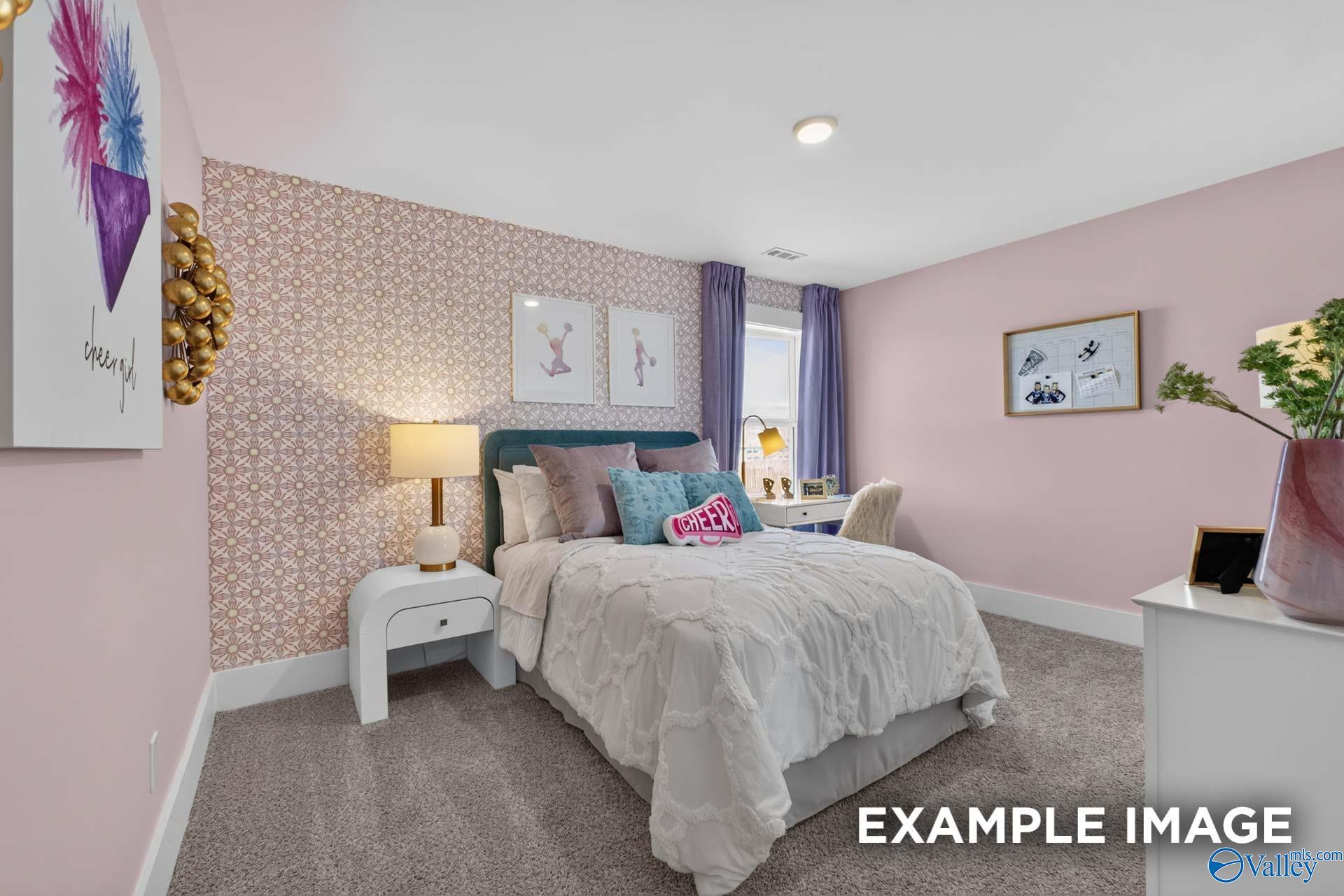 Charming pink bedroom with patterned accent wall and cozy bed in Davidson Homes Ashport K plan, Forest Glen, Hazel Green, Alabama