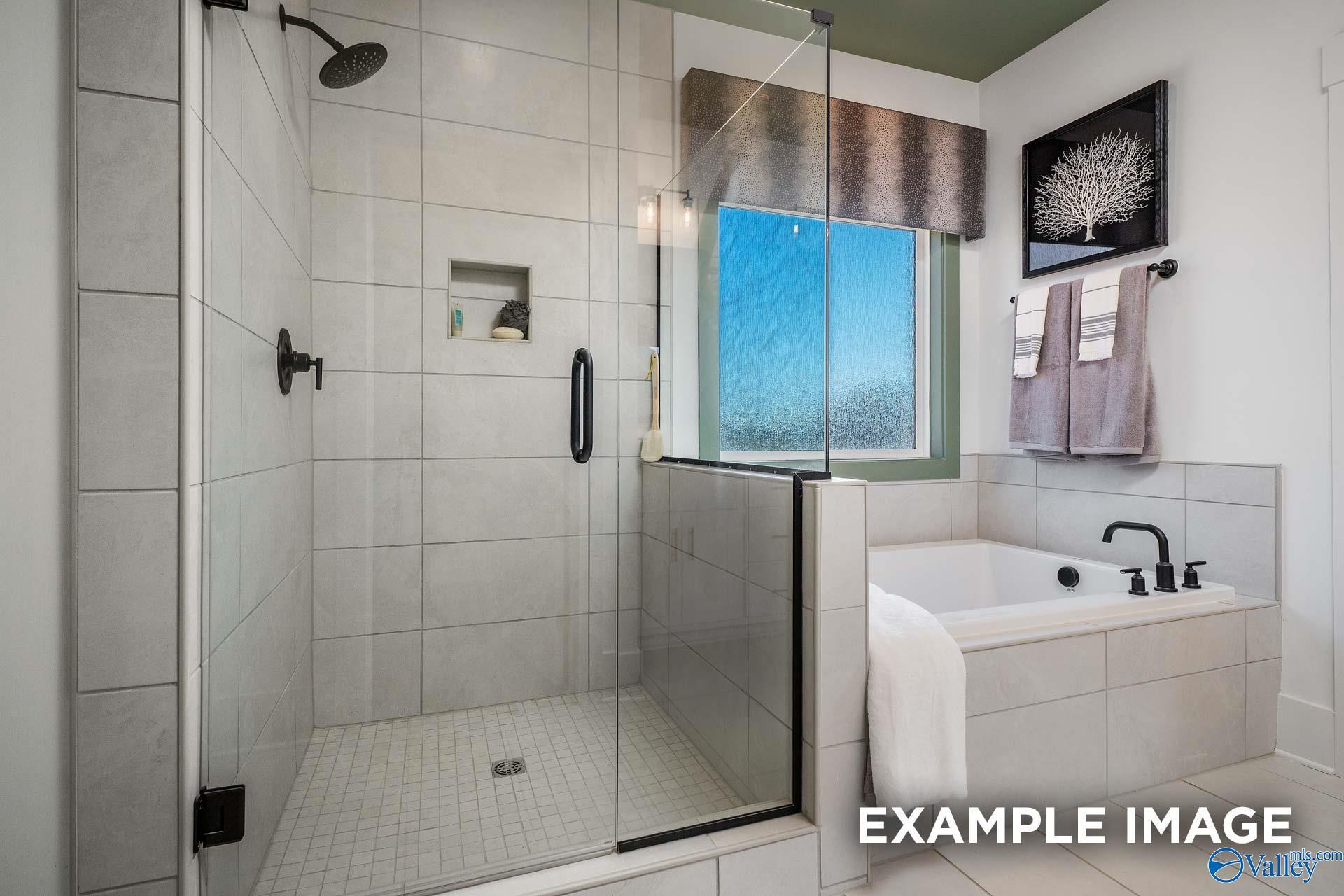 Modern master bathroom with frameless glass shower, soaking tub, subway tile in Davidson Homes The Rockford B, Madison, Alabama