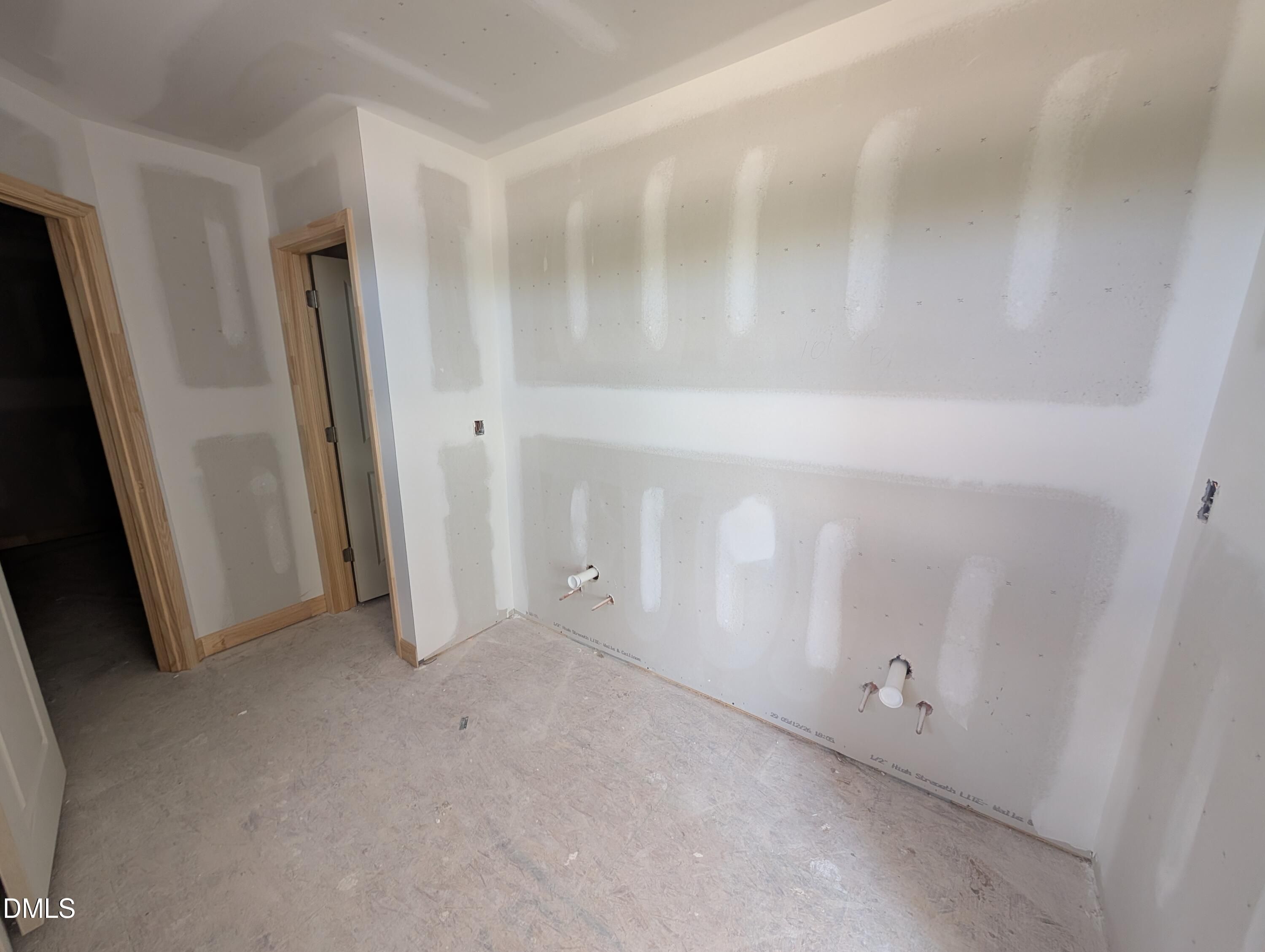 Unfinished bathroom construction with drywall and plumbing pipes in The Chestnut floor plan at Wendell Ridge, North Carolina.
