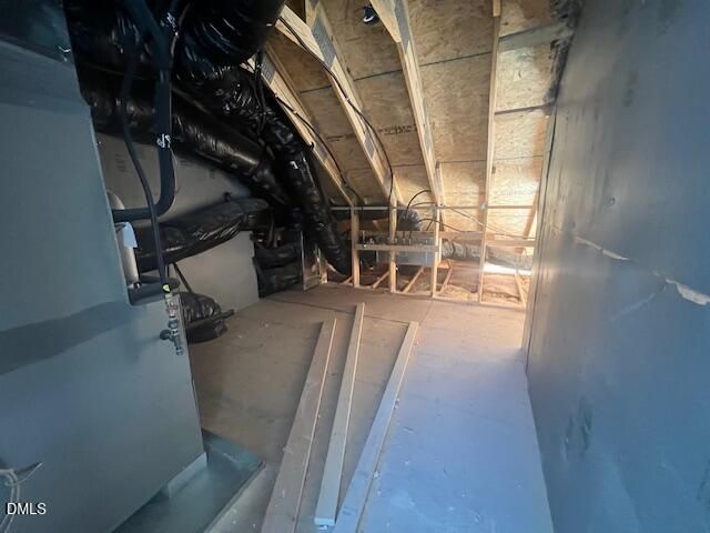 Unfinished attic storage space with HVAC ductwork and wooden framing in Davidson Homes The Ash C, Lillington, North Carolina