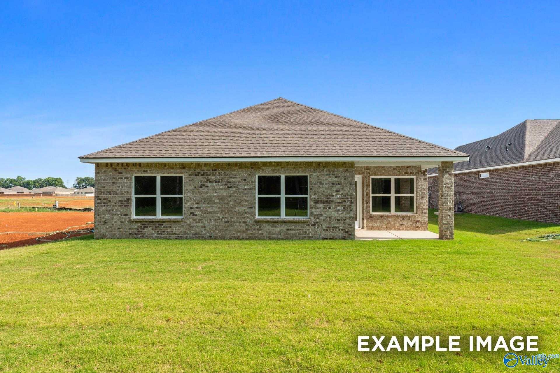 Single-story brick 4-bedroom home with gabled roof, covered porch, and green lawn in The Highlands, Arab, Alabama