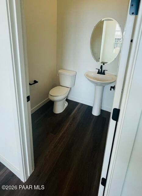 Modern powder room with pedestal sink and oval mirror in The Aurea C floor plan at Hidden Hills, Prescott, Arizona.