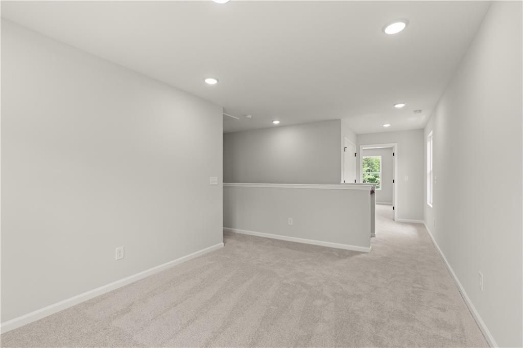 Spacious carpeted loft area in The Hartwell A floor plan by Davidson Homes at The Bluffs in Canton, Georgia.