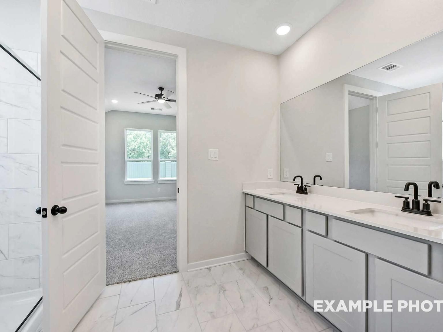 Modern bathroom with double vanity and walk-in shower in The Sequoia C floor plan by Davidson Homes in Sundance Cove.