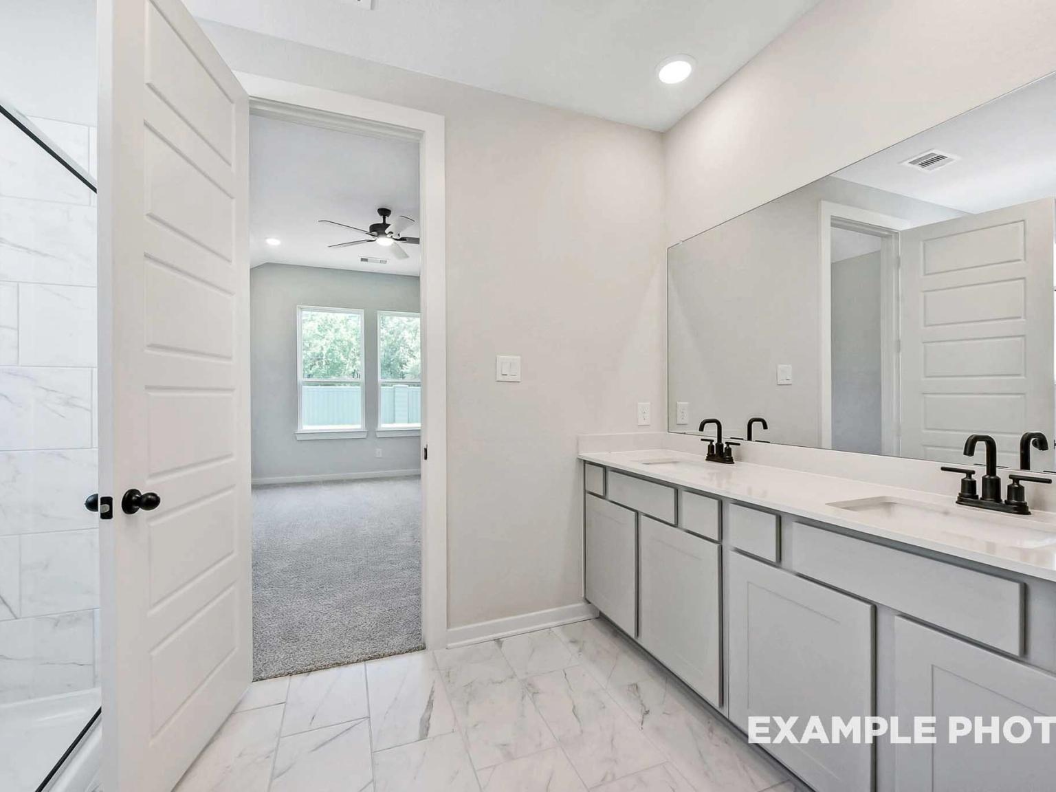 Modern bathroom with double vanity and walk-in shower in The Sequoia C floor plan by Davidson Homes in Sundance Cove.
