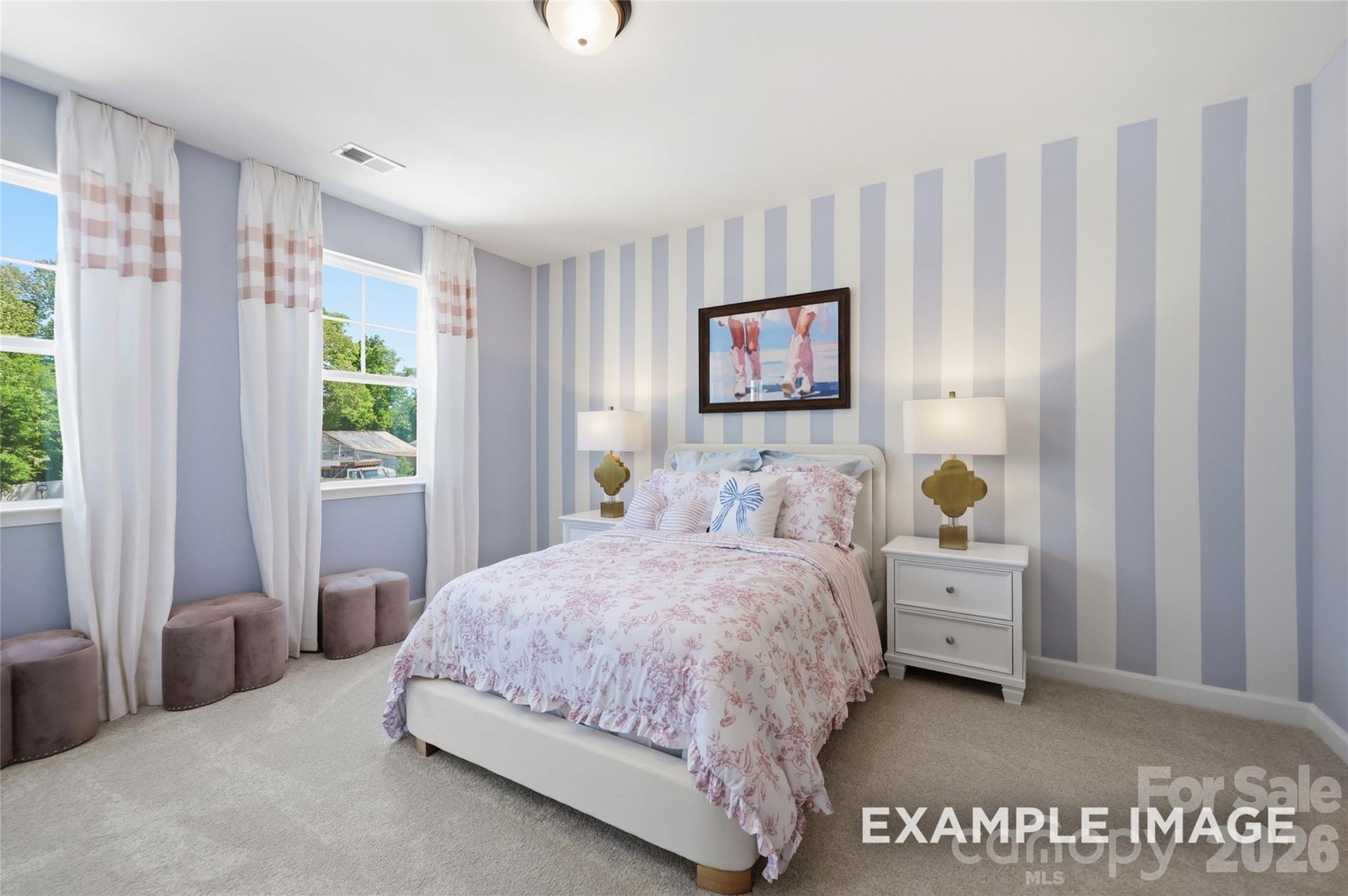 Bright lavender bedroom with striped accent wall and floral bedding in Davidson Homes The Aspen B, Mooresville, NC
