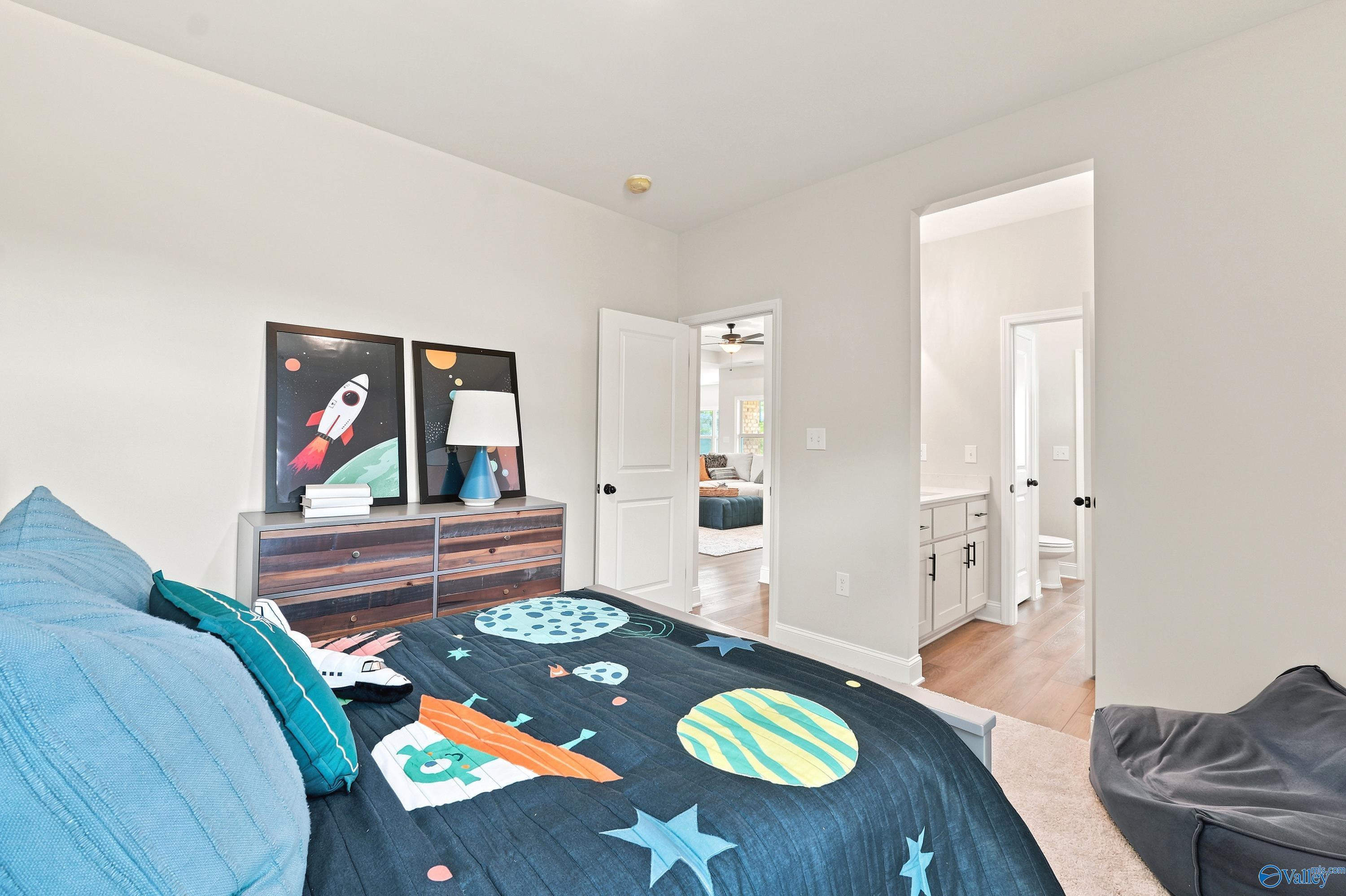 Space-themed bedroom with ensuite bathroom in The Finleigh floor plan at Riverton Preserve, Huntsville, Alabama.