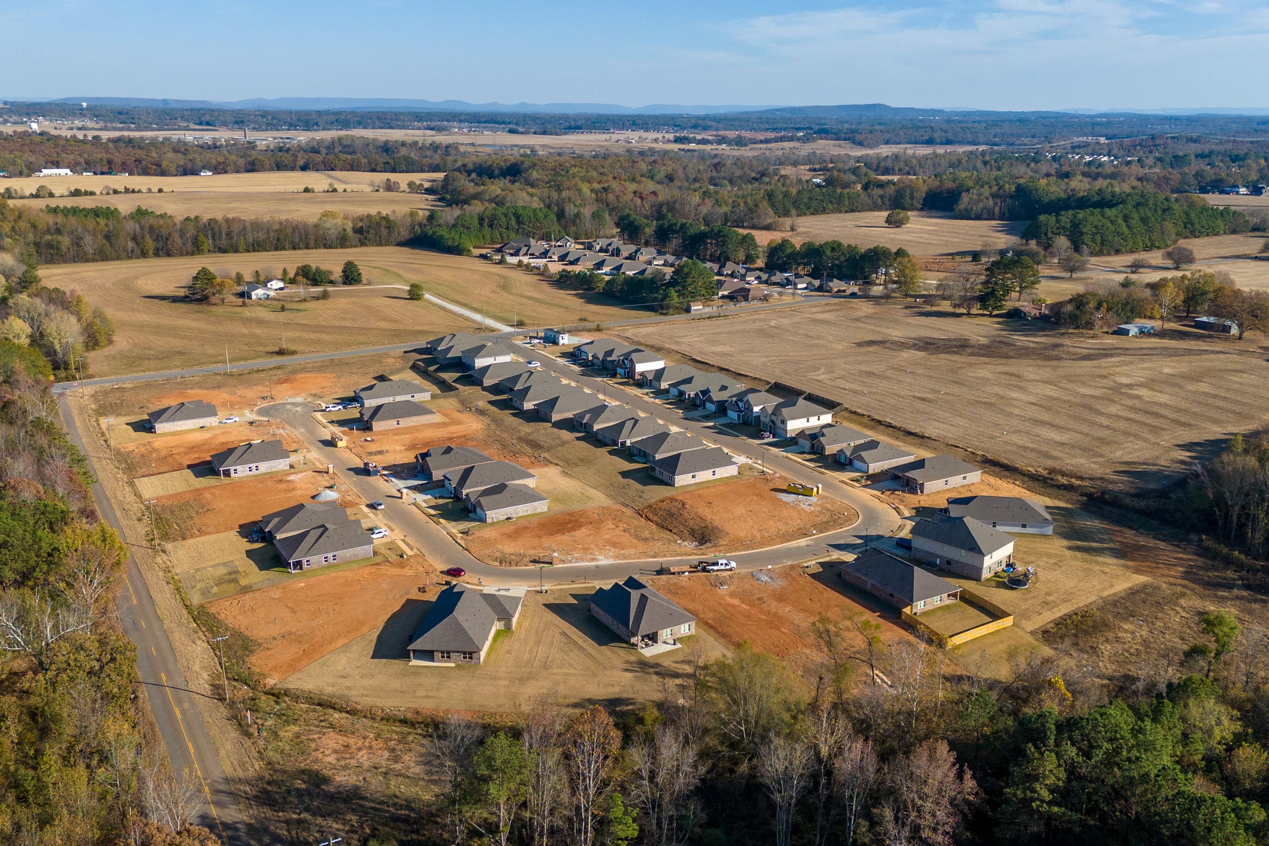 Aerial view of new construction homes at Mallard Landing in Athens Alabama by Davidson Homes amid fields and woods