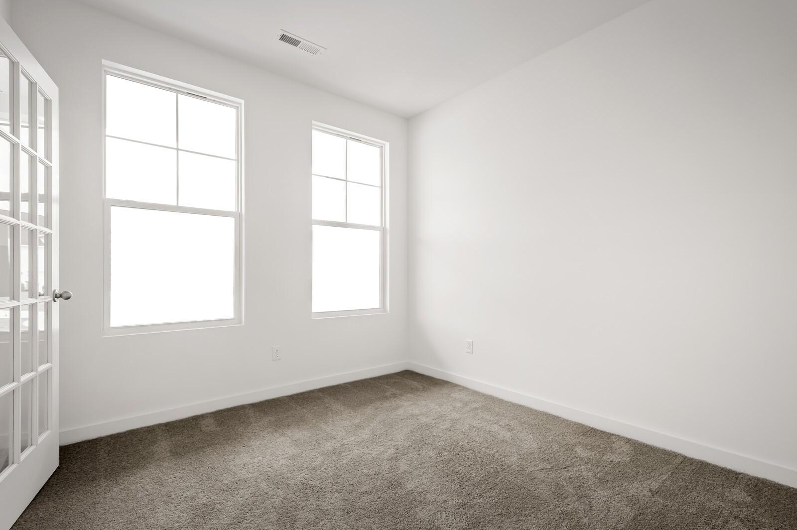 Bright, carpeted flex room with French doors in The Logan C floor plan at Calista Farms, White House, Tennessee.