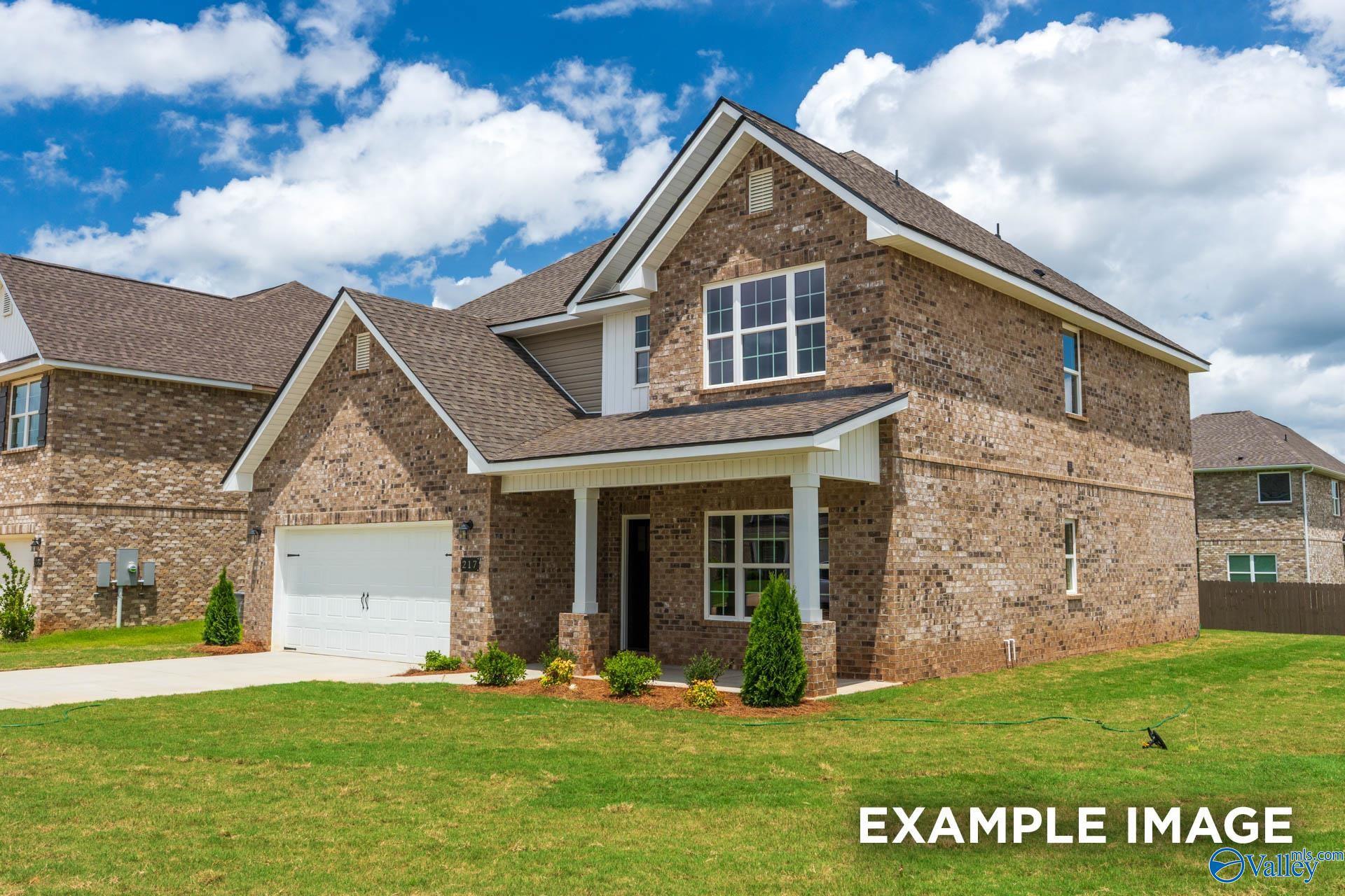 Two-story brick home with 2-car garage, covered porch, and landscaped yard in Ivy Hills, Toney, Alabama by Davidson Homes
