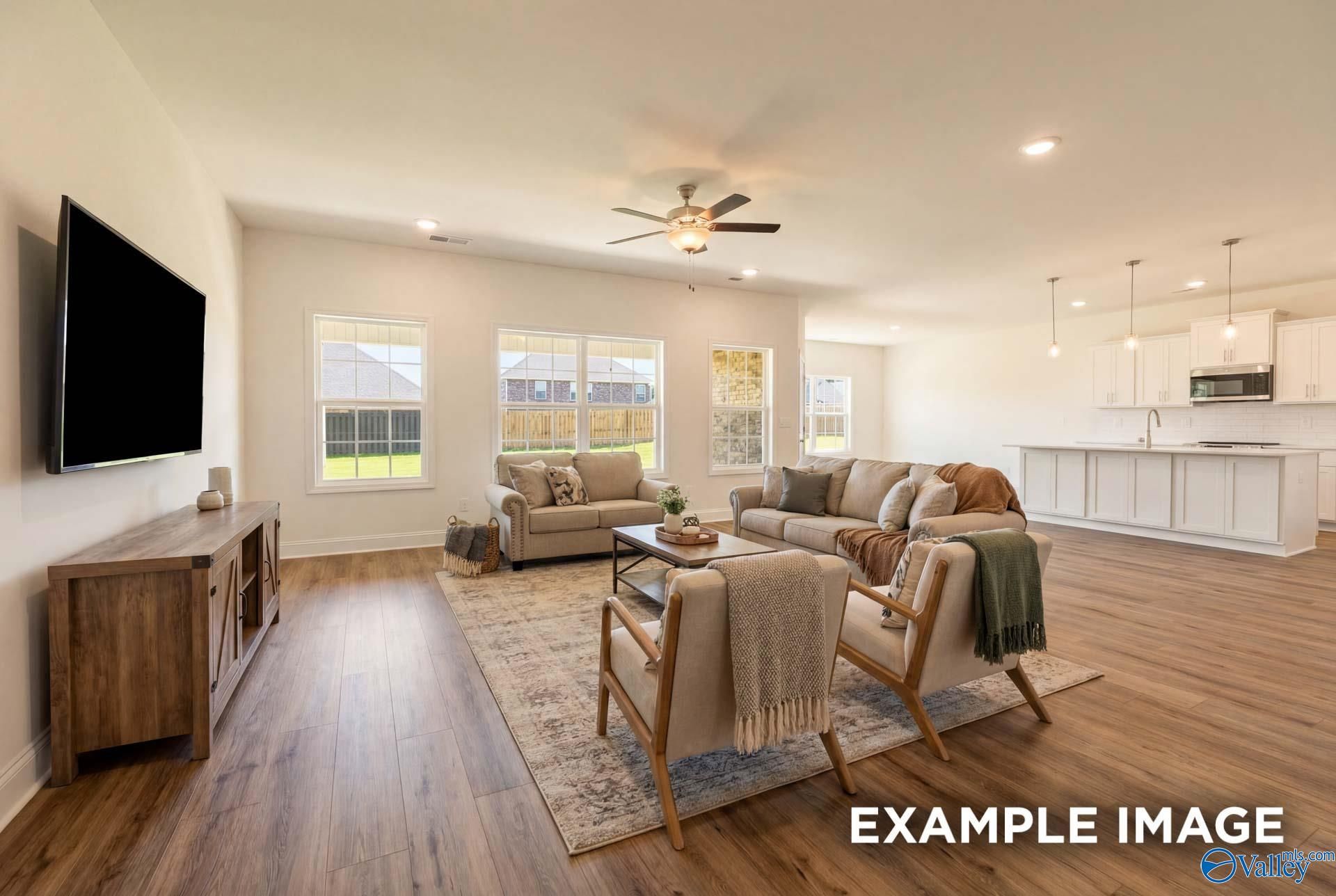Open-concept living room and kitchen in The Rockford B floor plan at Kendall Downs, Toney, Alabama.