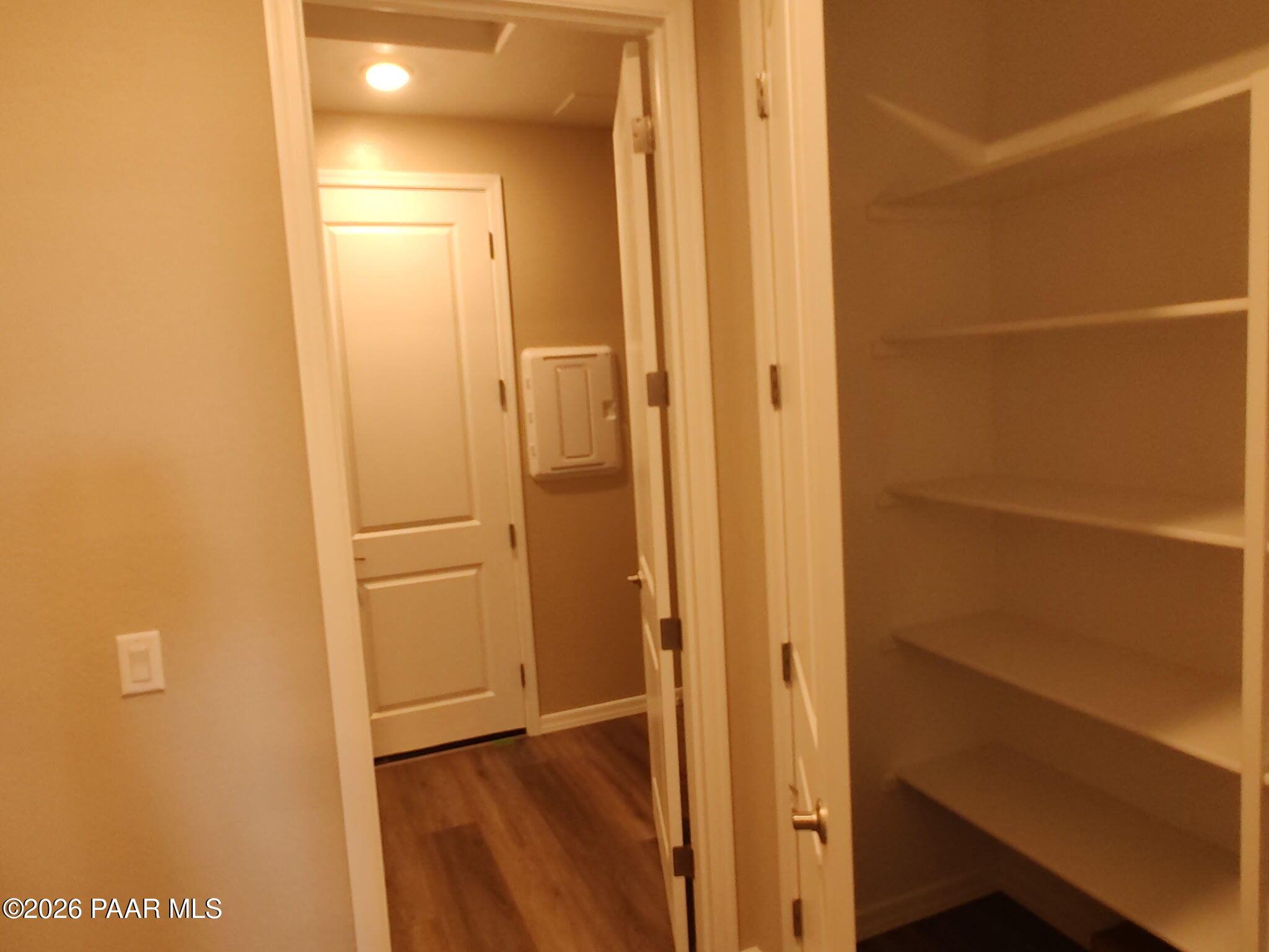 Walk-in storage closet with white shelving in The Inspiration C floor plan at North Ridge, Pronghorn Ranch, Prescott Valley.