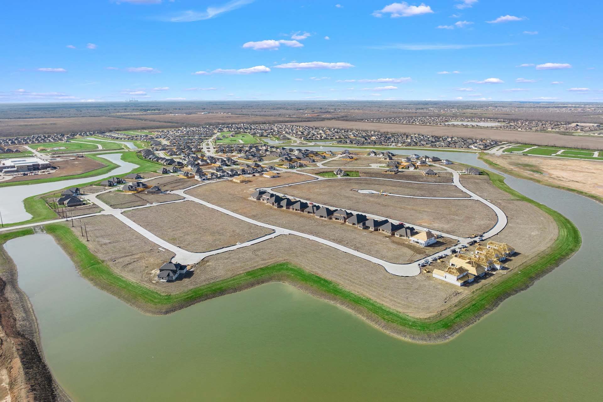 Aerial view of Sierra Vista neighborhood in Rosharon Texas with new Davidson Homes along waterfront lots and green spaces